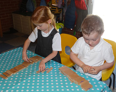photo showing two children from grasshopper playing at Longscroft