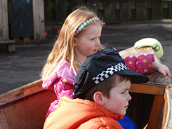 photo showing two children playing in the playground boat