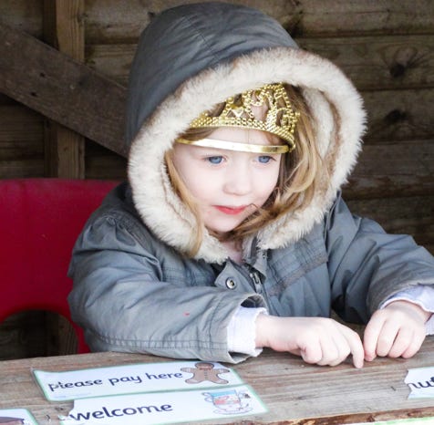 Photo of girl playing outdoor in play shop at Longscroft Nursery